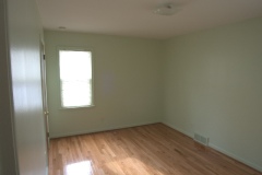 Bedroom 1: two windows, closet, view towards back yard
