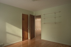 Bedroom 2: hardwood floors, closet, view towards hallway