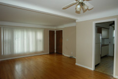 Dining / Living room: vertical blinds, coat closet, door to entrance hallway, cable-tv connections, kitchen doorway.